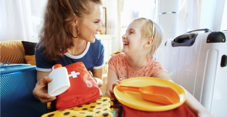 mother and daughter packing medical supplies and clothes